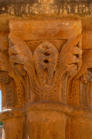 Close-up of intricate sculptures on a column at Monasterio de San Juan de Duero in Soria, Spain. The...