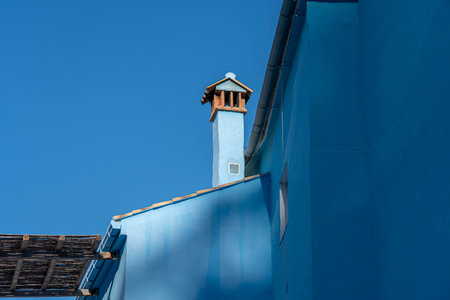 A picturesque view of JÃºzcar, the blue-painted village in Andalusia, Spain, bathed in morning sunlight. Perfect for travel brochures, cultural features, or serene landscape themes.の写真素材