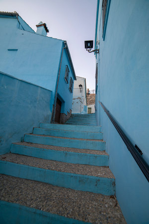 A quiet alley in JÃºzcar, Spain, lined with vibrant blue buildings, capturing the unique charm of the "Smurf Village." Perfect for travel, architecture, or cultural themes.の写真素材