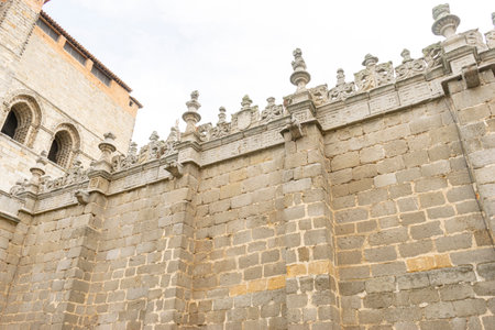 Intricate Stone Walls of Ãvila Cathedral with Historic Streets Viewの写真素材