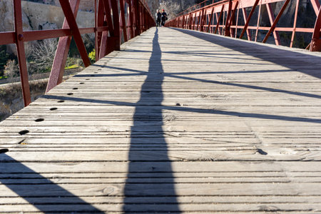 Iron Bridge Overlooking the Famous Hanging Houses of Cuencaの写真素材