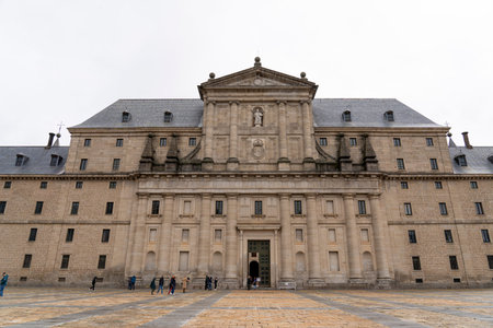 Visitors explore the impressive faÃ§ade of Monasterio de El Escorial in Spain. This UNESCO World...