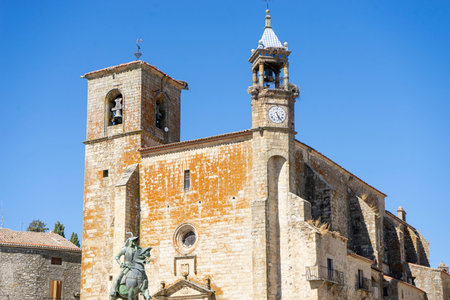 Historic church in Trujillo, Extremadura stands tall against a cloudless blue sky. The architectural...