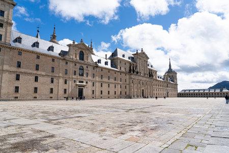 Tourists explore the impressive Monasterio de El Escorial, a UNESCO World Heritage Site, surrounded...