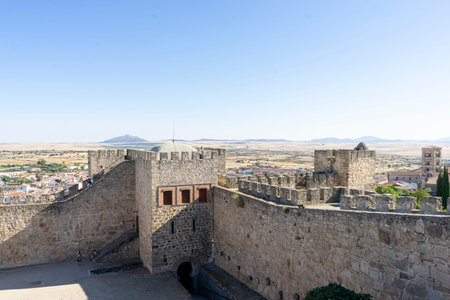 Explore the ancient castle in Trujillo, Extremadura, featuring robust stone walls and towers. The...