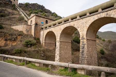 Stone bridge with arches and hillside background.. Pueblo de Patones de Arriba in Madrid, known for its slate architecture and for evading the French invasion., roadの写真素材