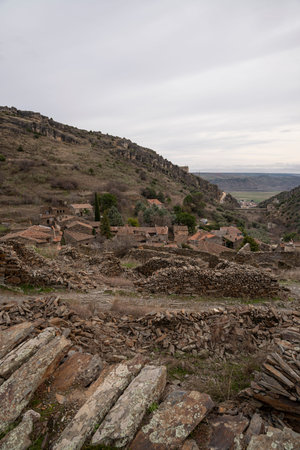 Rugged landscape with stone structures and hills.. Pueblo de Patones de Arriba in Madrid, famous for its slate architecture and for evading the French invasion., viewの写真素材