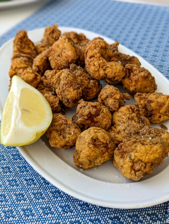 Fried food served on a white plate with lemon., crispyの写真素材