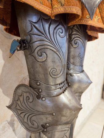 Close-up of ornate metal armor and fabric., design