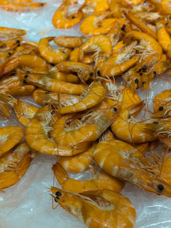 Numerous orange shrimp piled together on a surface., seafoodの写真素材