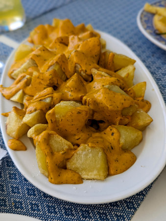 Plate of golden fried potatoes with sauce., foodの写真素材