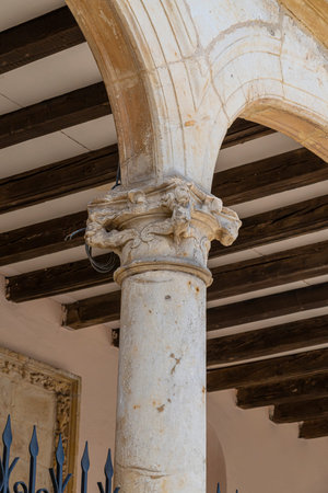 Column with decorative capital under wooden beams.. MÃ¡laga, Spain, architecture