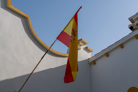 Spanish flag waving against a clear blue sky.. MÃ¡laga, Spain, whiteの写真素材