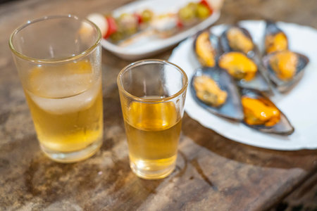Two glasses with drinks and a plate of mussels.. MÃ¡laga, Spain, foodの写真素材