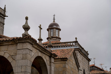 Stone church with a dome and cross.. Parish Church of Our Lady of the Assumption in La Alberca, Salamanca, Spain, roofの写真素材