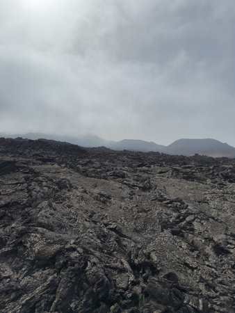 Lava fields under a cloudy sky in Timanfaya.. Volcanic landscape of Timanfaya, Lanzarote, Spain,...