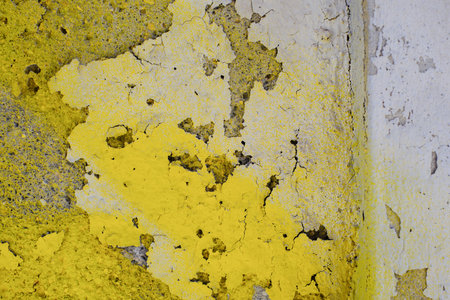Abstract yellow and gray peeling paint texture on concrete wall surface.の写真素材