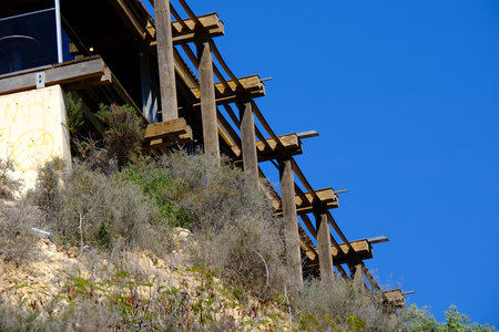 Modern architectural structure with blue sky and natural vegetation.の写真素材