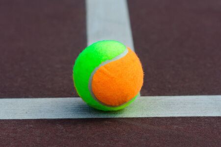 Tennis balls and rocket on court field in sunny day, sport, hobbyの写真素材