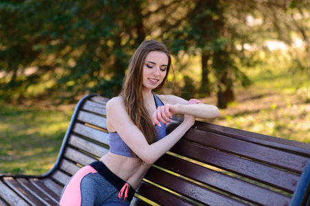 A close up of attractive young woman running, doing fitness outdoors
