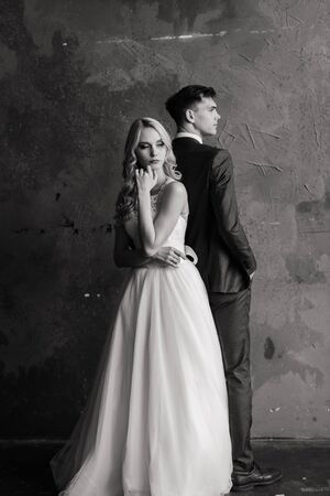Cute wedding couple in the interior of a classic studio.の写真素材