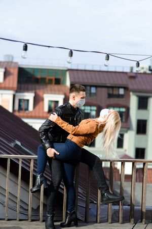 Young couple in masks on city street. Isolation, quarantine.の写真素材