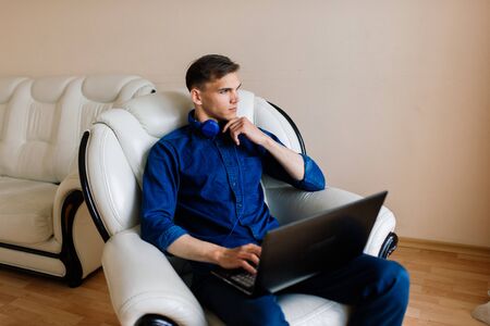 Businessman dressed in shirt having video call on computer in the home officeの写真素材