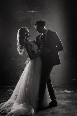 Art fashion studio photo of wedding couple silhouette groom and bride on colors background.の写真素材
