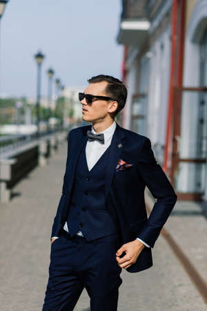 Portrait of an attractive young businessman in urban background wearing suit a necktie.の写真素材