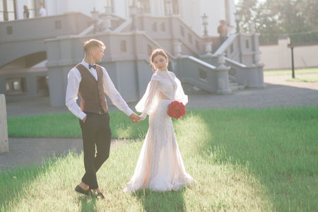 Happy just married young couple celebrating and have fun outdoors, kissingの写真素材