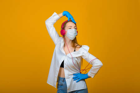 The caucasian girl in blue colored protective face mask. The girl looking at camera. virus and pollution protection concept.の写真素材