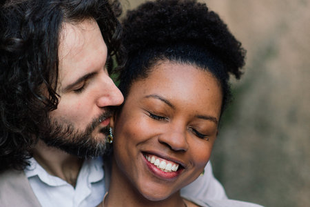 Milan, Italy - 02.04.2020. Young adult interracial couple on a beach, Caucasian man and African...