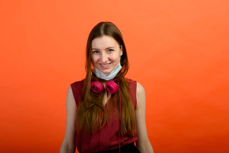 Girl in protective medical mask and blue gloves on red background. close-up portrait of a woman in a...