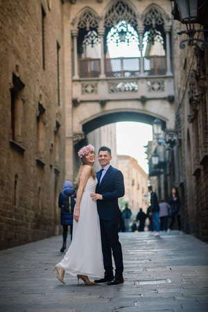 Barcelona, Spain - 03.02.2020. Just married couple walking in the streets of Barcelona, in beautiful wedding dress and lovely flowers.のeditorial素材