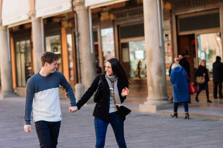 Bologne, Italy - 02.05.2020. Young fashion couple walking down the street in summer in europe.のeditorial素材