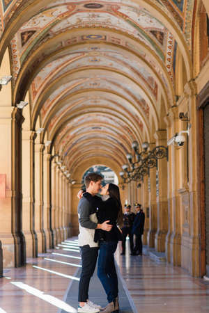 Bologne, Italy - 02.05.2020. Young fashion couple walking down the street in summer in europe.のeditorial素材