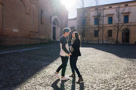Bologne, Italy - 02.05.2020. Young fashion couple walking down the street in summer in europe.のeditorial素材