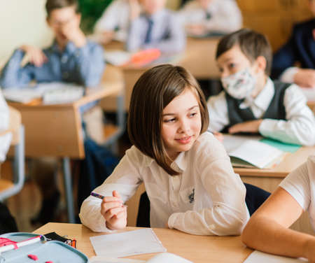 Minsk, Belarus - 09.01.2020. Elementary schoolchildren writing in books in classroomのeditorial素材