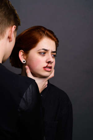 Desparate wife with aggressive husband in domestic violence concの写真素材