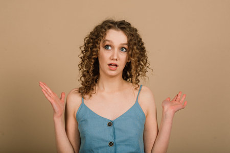 Emotional portrait of surprised woman. Amazement emotion. Studio isolated shot.