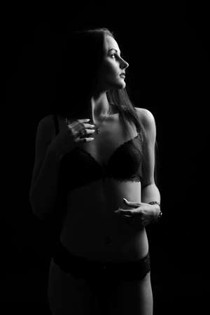 Beautiful sexy woman in blue underwear on a dark background, perfect female body, studio shotの写真素材
