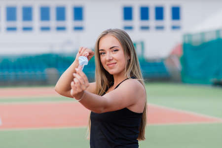 Female tennis player playing with protective mask on courtの写真素材