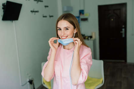 Beautiful female medical worker or manicure master in medical maskの写真素材
