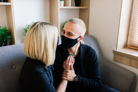 Loving couple in cafe with face mask during quarantine, covid-19.