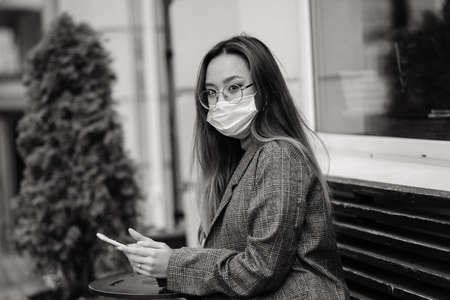Young asian woman with surgical mask face protection. She commutes between home and workplace in cityの写真素材