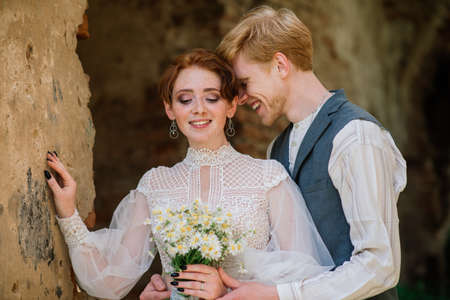 Very nice redhead young just married happy couple kissing in the sunset outdoorsの写真素材