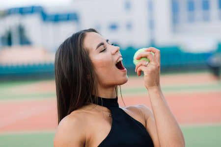 Beautiful stylish sexy woman in a trendy sportswear on tennis court.の写真素材