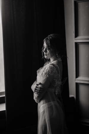 Beautiful young bride in a white lingerie. Last preparations for the wedding. The girl is waiting for the groom.の写真素材