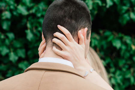 Salo, Italy - 02.02.2020. Romantic young couple sitting on the river dock and walking on the lake bank.のeditorial素材