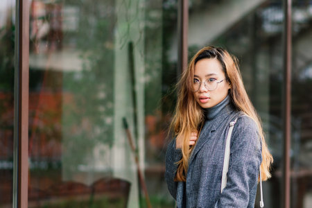 Happy asian woman student on city street, education conceptの写真素材